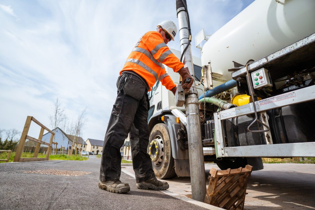 West Wales Waste operative cleaning a gully in Pembroke, Pembrokeshire - alternative view